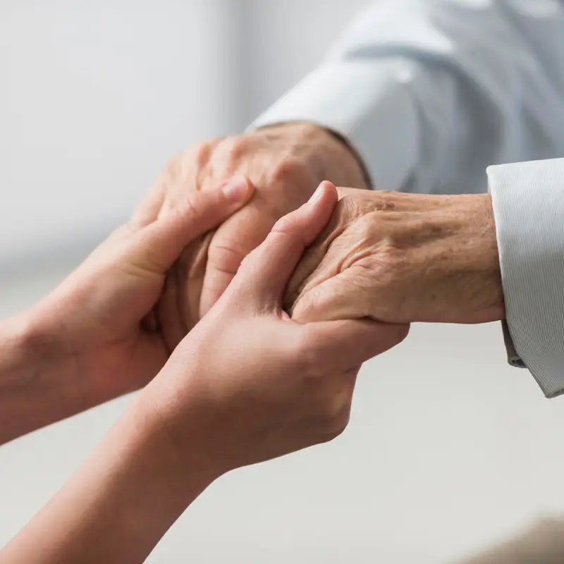 nurse-holding-senior-man-s-hands-sympathy